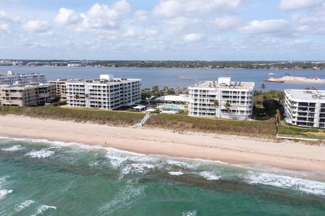 birds eye view of property with a water view and a view of the beach