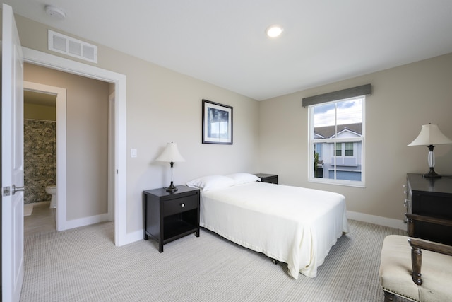 carpeted bedroom featuring connected bathroom