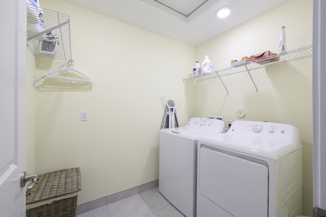 laundry area featuring washer and dryer and light tile patterned flooring