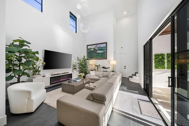 living room with a notable chandelier and a high ceiling