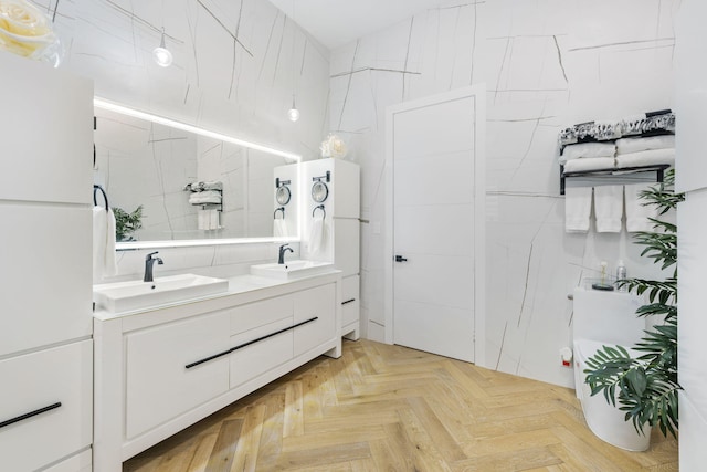 bathroom featuring tile walls, parquet flooring, and vanity