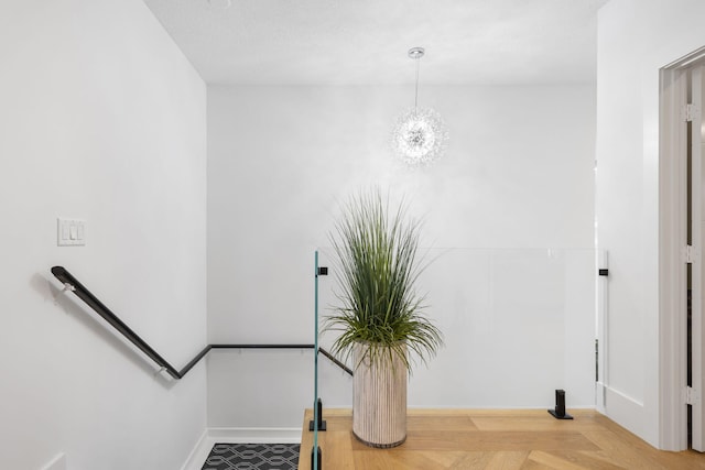 stairs featuring a textured ceiling and parquet flooring