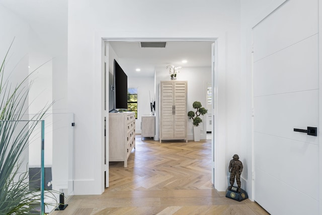 corridor with light parquet floors