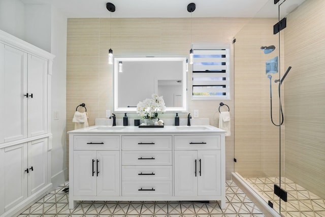 bathroom with tile walls, tile patterned flooring, vanity, and a shower with door