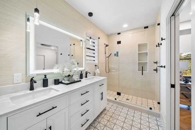 bathroom with tile patterned floors, vanity, and walk in shower