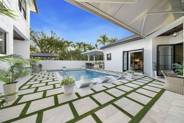 view of swimming pool with an outdoor bar and a patio