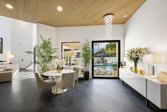 dining room with a towering ceiling