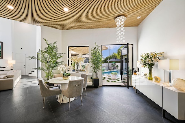 dining space featuring a towering ceiling