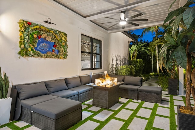 view of patio featuring ceiling fan and an outdoor living space with a fire pit