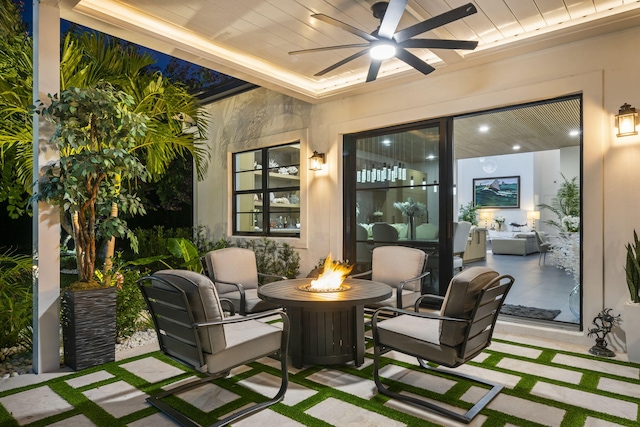 view of patio / terrace with ceiling fan and an outdoor fire pit