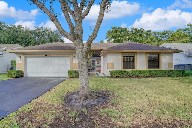 ranch-style house featuring a garage and a front lawn