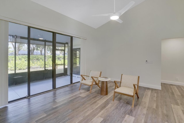 living area featuring ceiling fan and light hardwood / wood-style floors