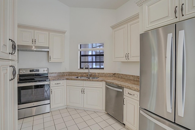 kitchen with light stone countertops, light tile patterned floors, sink, and appliances with stainless steel finishes