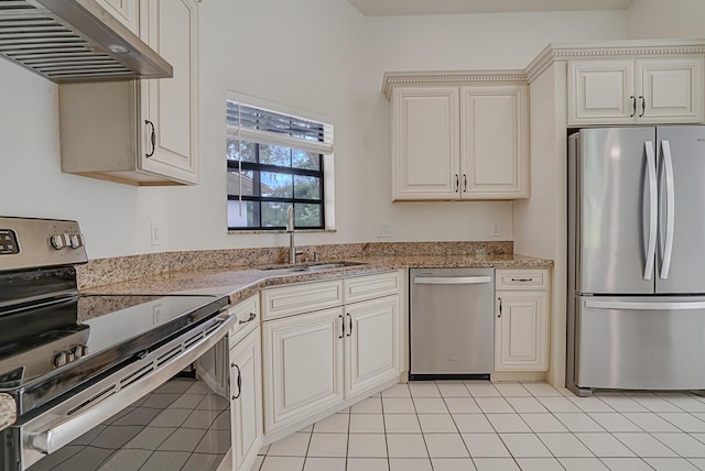 kitchen featuring light stone counters, stainless steel appliances, sink, exhaust hood, and light tile patterned floors