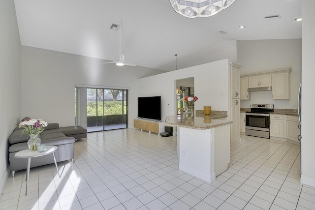 kitchen featuring high vaulted ceiling, light stone counters, stainless steel electric range oven, and light tile patterned floors