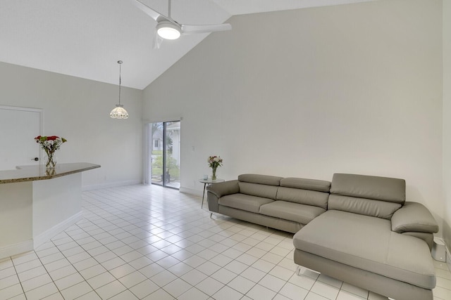 tiled living room with high vaulted ceiling and ceiling fan