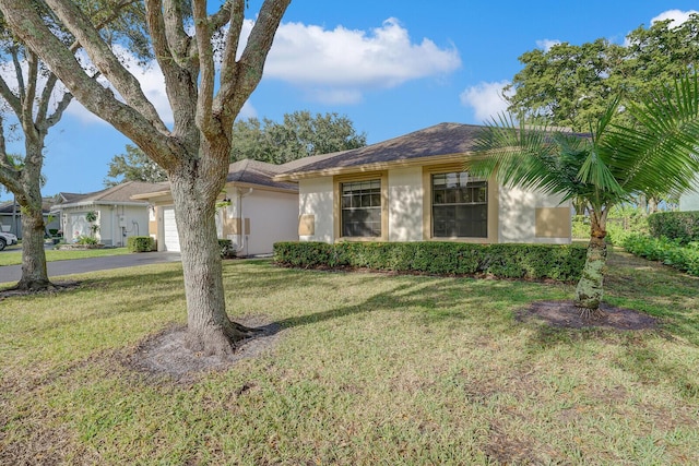 ranch-style house with a garage and a front yard