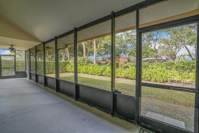 unfurnished sunroom featuring vaulted ceiling