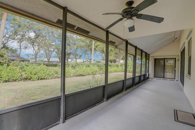 unfurnished sunroom with ceiling fan and lofted ceiling