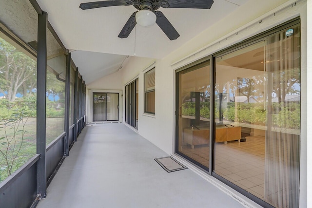 unfurnished sunroom with vaulted ceiling and ceiling fan