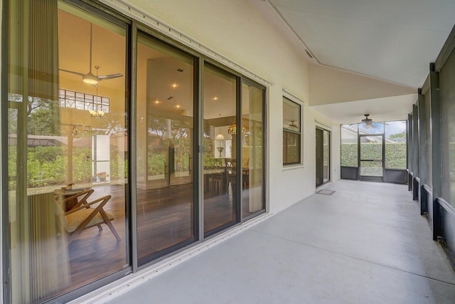 unfurnished sunroom featuring vaulted ceiling and ceiling fan