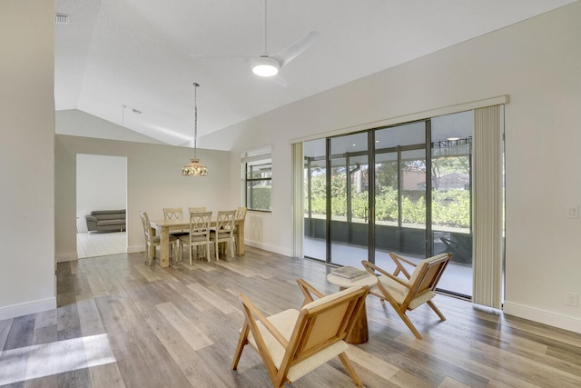 dining area featuring light hardwood / wood-style floors, a wealth of natural light, and vaulted ceiling