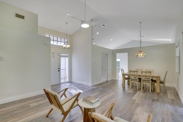 interior space with ceiling fan, high vaulted ceiling, and light wood-type flooring