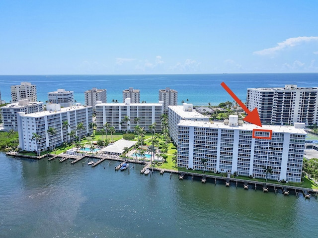 drone / aerial view featuring a view of city and a water view