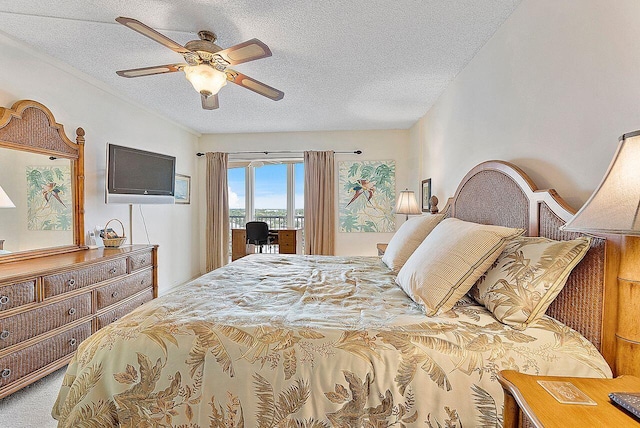 bedroom featuring ceiling fan, carpet, access to outside, and a textured ceiling