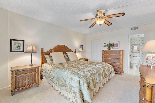 bedroom with connected bathroom, light colored carpet, a textured ceiling, a closet, and ceiling fan