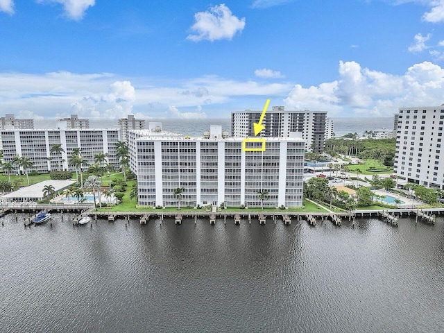 birds eye view of property featuring a water view and a city view