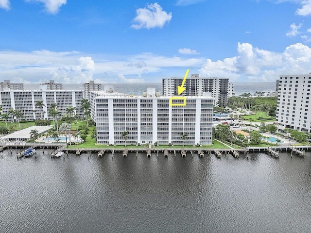 birds eye view of property with a water view and a view of city