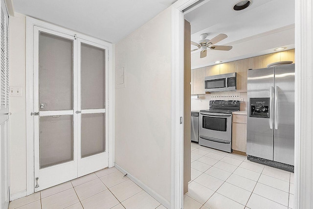 kitchen featuring light brown cabinetry, light tile patterned floors, ceiling fan, and appliances with stainless steel finishes