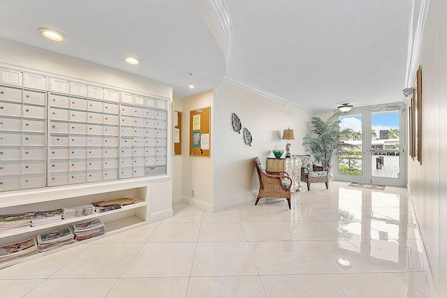 corridor with light tile patterned floors, crown molding, and mail boxes