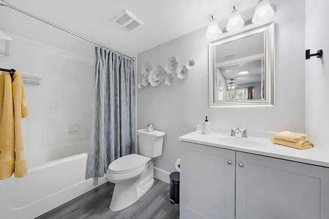 full bathroom featuring vanity, wood-type flooring, a textured ceiling, toilet, and shower / bath combo with shower curtain