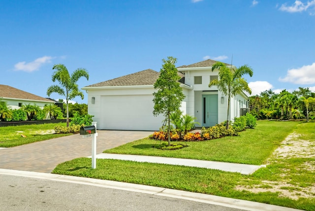 mediterranean / spanish-style house with a garage and a front yard