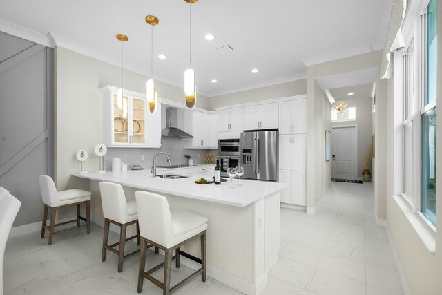 kitchen featuring wall chimney range hood, tasteful backsplash, double oven, black electric stovetop, and white cabinets