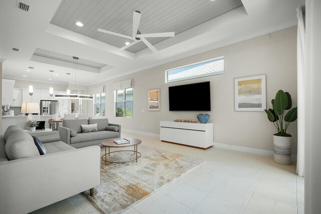 spare room featuring a tray ceiling, light wood-type flooring, and ornamental molding