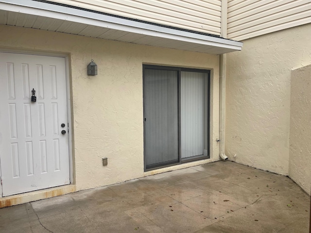 property entrance with a patio