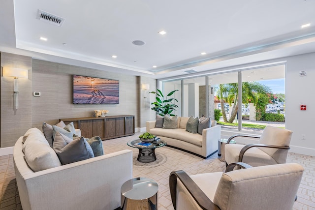 living room featuring a raised ceiling