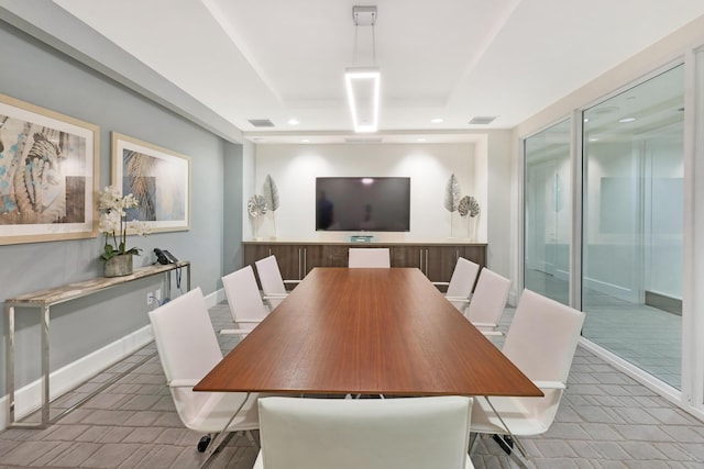 dining room with a raised ceiling