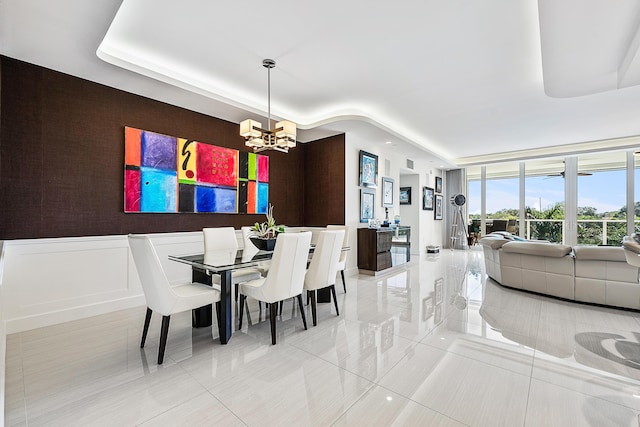 tiled dining room with a notable chandelier