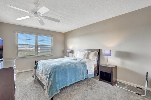 bedroom featuring a textured ceiling, ceiling fan, and light carpet