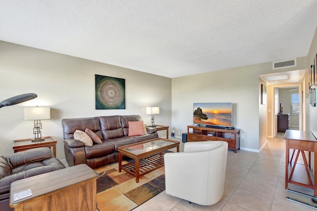 tiled living room with a textured ceiling