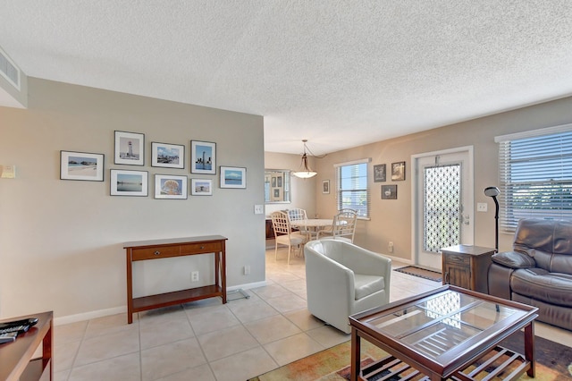 tiled living room with a wealth of natural light and a textured ceiling