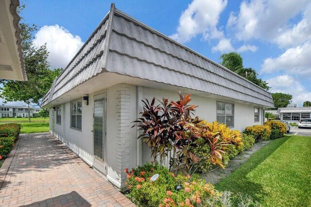 view of property exterior featuring a lawn