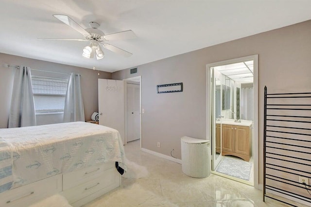 bedroom with ensuite bath and ceiling fan