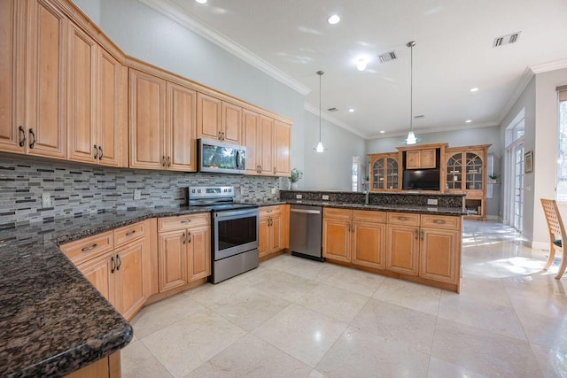 kitchen featuring pendant lighting, sink, tasteful backsplash, kitchen peninsula, and stainless steel appliances