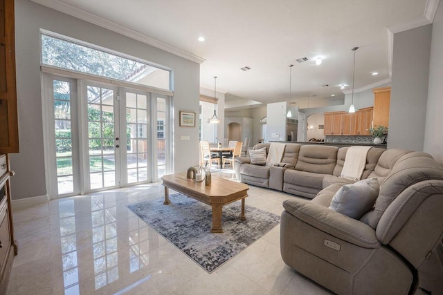 living room with ornamental molding and french doors