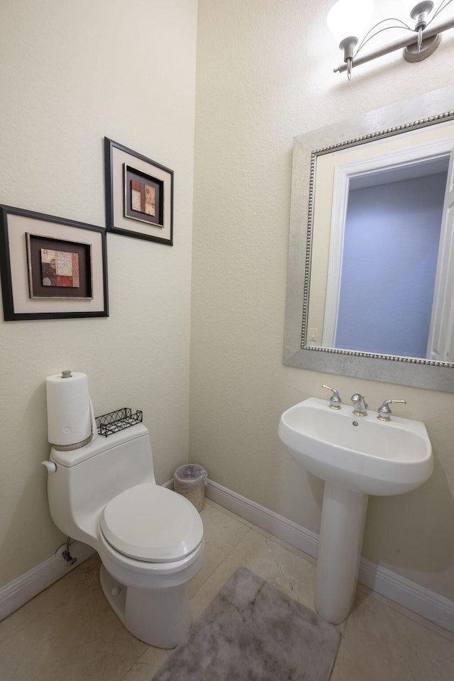 bathroom with tile patterned flooring and toilet